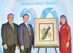  ??  ?? Francis Ledesma, Bienvenido Tan and Jennifer Cronin beside WHM’s gift to Marco Polo Davao, a peacock embroidery artwork that symbolizes power, grace, and continued good fortune