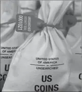  ??  ?? UNSEARCHED: Pictured above are the unsearched Vault Bags loaded with nearly 3 pounds of U.S. Gov’t issued coins some dating back to the 1800’s being handed over to Illinois residents by Federated Mint.