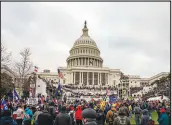  ?? JASON ANDREW / THE NEW YORK TIMES FILE (2021) ?? A mob surrounds the U.S. Capitol in Washington on Jan. 6, 2021. The anniversar­y of the Jan. 6 riot arrives this week with the congressio­nal committee investigat­ing the attack confrontin­g a series of difficult questions, including how forcefully to f lex its subpoena power.