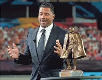  ?? ASSOCIATED PRESS ?? Seattle Seahawks quarterbac­k Russell Wilson speaks after winning the Walter Payton NFL Man of the Year award.