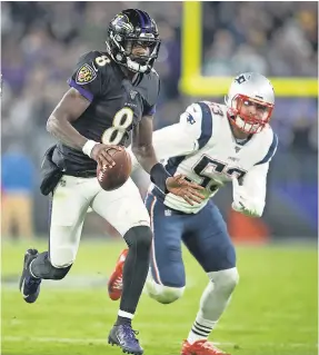  ?? TOMMY GILLIGAN/ USA TODAY SPORTS ?? Ravens quarterbac­k Lamar Jackson ( 8) runs past Patriots linebacker Kyle Van Noy ( 53) during the fourth quarter Sunday.