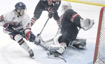  ?? JASON MALLOY PHOTOS ?? Truro Bearcats goalie Connor Martin kicks out his left pad to stop Valley Wildcats right-winger Cole McKeigan during the third period of a tied Game 2 March 20 at the Kings Mutual Century Centre in Berwick. The Bearcats won the game 3-2 in overtime to tie the best-of-seven Maritime Junior Hockey League quarter-final 1-1.