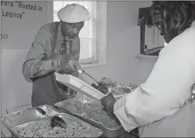  ?? Photos by Diane Wagner, Rome News-Tribune ?? BELOW: John Ware (left) dishes up a helping of jambalaya and rice for Rosemary Shropshire.