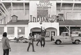  ?? Associated Press 1969 ?? American Indians play ball games outside the prison wall on Alcatraz during their occupation of the island in an attempt to reclaim it in November 1969.