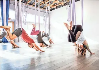  ??  ?? Join Elevate Yoga & Wellness’ “Galentine’s Day” class on Feb. 13 to soar through the air on aerial hammocks in a guided 75-minute class.