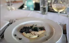  ??  ?? Butter and thyme basted line fish with cauliflowe­r purée, red wine braised lentils and crispy kale served with Pierre Jourdan Tranquille.