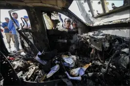  ?? ABDEL KAREEM HANA — THE ASSOCIATED PRESS FILE ?? People on April 2 inspect the site where World Central Kitchen workers were killed in Deir al-Balah, Gaza Strip, April 2.