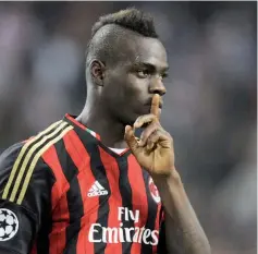  ?? — AFP photo ?? AC Milan’s Italian forward Mario Balotelli gestures after scoring a penalty during the UEFA Champions League group H football match Ajax Amsterdam vs AC Milan on October 1, 2013 at the Amsterdam ArenA in Amsterdam.