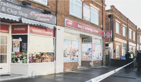  ??  ?? Police taped off Bal’s General Store in St John’s Street