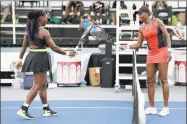  ?? Dylan Buell / Getty Images ?? Serena, left, and Venus Williams touch rackets after Serena defeated Venus at the Top Seed Open.