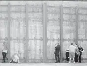  ?? Nelvin C. Cepeda San Diego Union-Tribune ?? PEOPLE on the San Diego side of the border visit with family through the fence at Friendship Park.