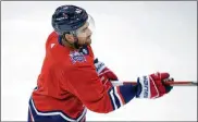  ??  ?? Washington Capitals forward TomWilsonw­ears a helmet bearing a Capital One logo during practice Monday in Arlington, Va. The league will try to recoup lost revenue with helmet ads this season.