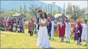  ?? PTI ?? Bystanders watch shooting of a Bollywood film at Tulip Garden in Srinagar Friday.