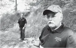  ?? MICHAEL RUBINKAM/2018 ?? Treasure hunters Dennis Parada and his son, Kem, stand at the site of the FBI’s dig for gold in Dents Run, Pennsylvan­ia. The FBI said it did not find anything.