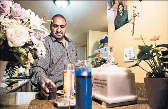  ?? ZBIGNIEW BZDAK/CHICAGO TRIBUNE PHOTOS ?? Rodolfo Reyes, 46, who lost his partner, Maria Isabel Alfaro, to COVID-19, has created a small memorial around her ashes at home in Chicago on Sept. 11, 2020.