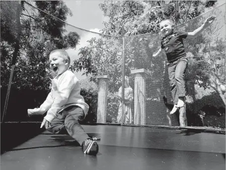  ?? Mel Melcon Los Angeles Times ?? LUCIAN OLIVERA, left, and brother Niko play in March. For now, experts say that enteroviru­s D-68, the suspected cause of Lucian’s illness, isn’t enough of a threat to make a vaccine and that many people now have immunity to the virus from an outbreak...