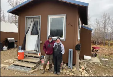  ?? Photo by RB Smith ?? TAKING CARE— John and Marisa Niell stand outside their new summer home, a one-room cabin more than an hour’s drive from Nome at Pilgrim Hot Springs.