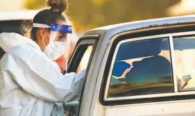  ?? Carlos Avila Gonzalez / The Chronicle 2020 ?? A driver gets a coronaviru­s test at the Alemany farmers’ market in San Francisco in November. Demand for tests has fallen as more people get vaccinated.