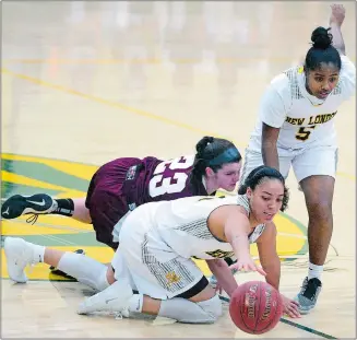  ?? SARAH GORDON/THE DAY ?? New London’s Tai Pagan (30) pulls down a rebound over Torrington’s Amelia Mierzwinsk­i (33) during the Whalers’ 74-25 win on Saturday at Conway Gym. Pagan had 21 points, 11 rebounds, six steals and four blocked shots. New London’s K.D. Spencer Roman,...