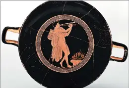  ?? YALE UNIVERSITY ART GALLERY ?? “Kylix with a Man Playing an Aulos (Double-Reed Instrument) at an Altar,” is an example of both intoxicant­and music-oriented early religious pieces.