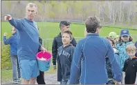  ?? CAPE BRETON POST PHOTO ?? John Borden leads a group of students from Shipyard Elementary as they prepare to race around the school as part of the Kid’s Run Club program.