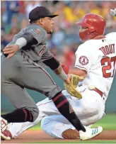  ??  ?? The Angels’ Mike Trout (27) is about to be tagged out by Diamondbac­ks shortstop Ketel Marte on a stolen-base attempt. For a complete game report, visit dbacks.azcentral.com. KIRBY LEE/USA TODAY SPORTS