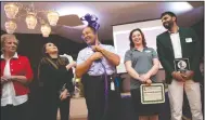  ??  ?? Linda Breier and Leslie Sanchez, on left, with MHA Building Systems and C&H Financial Service’s KarolAnn Osborn and Kanware Singh, on right, laugh as Chet Somera, center, Sales Manager at C&H Financial Services Inc., dons the ribbon on his head after a...