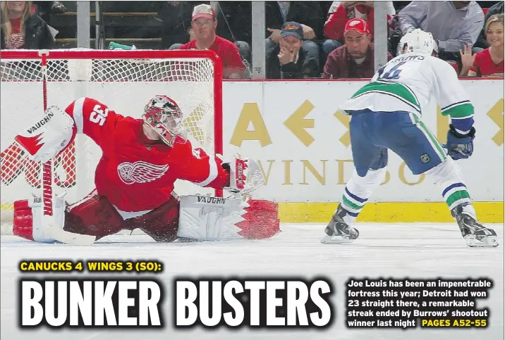  ?? — GETTY IMAGES ?? Vancouver’s Alex Burrows scores the game-winning goal on Detroit’s Jimmy Howard during the shootout that concluded Thursday’s game at Joe Louis Arena. Daniel Sedin had two goals — including the game-tying one with 15 seconds left in regulation — as the...