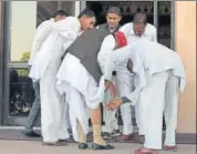  ?? PRABHAKAR SHARMA/HT PHOTO ?? Officials taking care of MLA Jai Narayan Punia, who stumbled while stepping down from stairs of the state assembly in Jaipur on Monday.