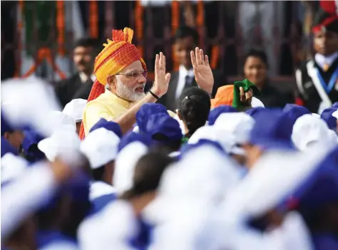  ??  ?? Indian Prime Minister Narendra Modi waves to children participat­ing in the country’s 71st Independen­ce Day celebratio­ns at the historic Red Fort in New Delhi on Tuesday. (AFP)