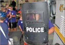  ??  ?? Omar Elzayatie, an Upper Dublin Junior Police Academy camper, holds a SWAT team shield.