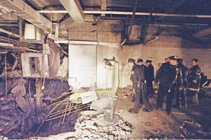  ?? RICHARD DREW/AP FILE ?? New York City police and firefighters inspect the bomb crater inside an undergroun­d parking garage of New York’s World Trade Center on Feb. 27, 1993, the day after an explosion tore through it.