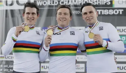  ??  ?? HONG KONG: From left, New Zealand’s Sam Webster, Ethan Mitchell and Edward Dawkins, celebrate on the podium after winning the gold medal in the Men’s Team Sprint at the World Track Cycling championsh­ips in Hong Kong, yesterday. —AP