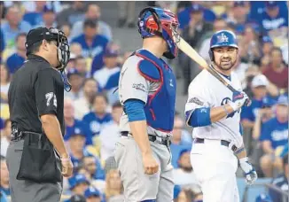  ?? Wally Skalij Los Angeles Times ?? DODGERS FIRST BASEMAN Adrian Gonzalez argues with plate umpire Alfonso Marquez after striking out in the second inning against Cubs ace Jon Lester. Gonzalez went 0 for 3.