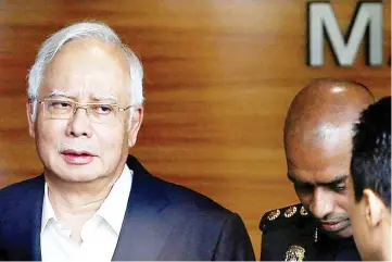 ??  ?? File photo shows Najib arriving at the Malaysian Anti-Corruption Commission headquarte­rs in Putrajaya on May 24, 2018, to give a statement.