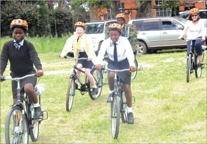  ??  ?? The United Kingdom’s Department for Internatio­nal Developmen­t has donated 3 000 bicycles as part of efforts to deliver quality education to marginalis­ed children in rural areas by reducing the time they spend travelling to school. Here, head of DFID Zimbabwe Annabel Gerry (far right) and four pupils enjoy a ride on some of the bicycles in Ruwa yesterday. — (Read story on Page 6). — (Picture by Edward Zvemisha)