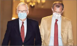  ?? Tasos Katopodis / Getty Images ?? U.S. Senate Majority Leader Mitch McConnell, R-Ky., left, walks to the Senate floor on Capitol Hill on Sunday in Washington, D.C.