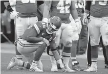  ??  ?? Chiefs quarterbac­k Patrick Mahomes kneels on the field after getting injured during the second half of a 22-17 win against the Browns on Sunday in Kansas City. [AP PHOTO/CHARLIE RIEDEL]