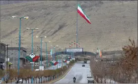  ?? (AP/Vahid Salemi) ?? Iran’s flag waves Wednesday at the entrance of Absard, the town where Mohsen Fakhrizade­h, an Iranian scientist linked to the country’s nuclear program, was killed last month east of Tehran.