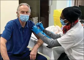  ??  ?? SHOT IN THE ARM: The former Prime Minister receives his first injection