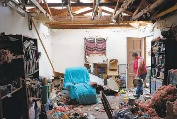  ?? Joe Raedle Getty Images ?? IN PANAMA CITY, Amanda Logsdon comes home to a shattered house. Wind speeds reached 155 mph as Hurricane Michael made landfall. As of late Thursday, at least six people had been killed by the storm.