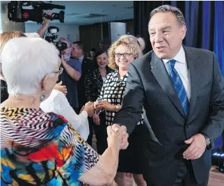  ?? PAUL CHIASSON/THE CANADIAN PRESS ?? Coalition Avenir Québec Leader François Legault greets voters at a seniors residence in Châteaugua­y on Monday. Legault suggested last week that 15 per cent of new immigrants to Quebec are unemployed during their first years in the province.