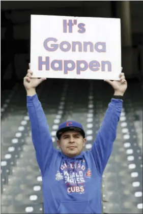  ?? THE ASSOCIATED PRESS ?? A Chicago Cubs fan holds up a sign before Game 1of the World Series on Tuesday night. The Cubs are making their first appearance in the World Series since 1945when they lost to the Tigers in seven games. That Fall Classic featured reserve players...