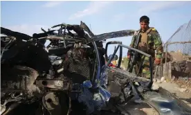  ?? Photograph: Ghulamulla­h Habibi/EPA ?? Afghan security officials inspect the scene of a road side bomb blast that killed six civilians on the outskirts of Jalalabad.