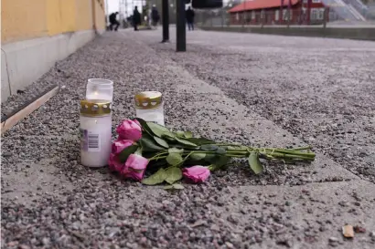  ?? ?? Blommor och tända ljus vid Södra station i Örebro där tre människor blev påkörda av ett godståg och miste livet.