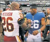  ?? N.Y. Post: Charles Wenzelberg ?? THE INSPIRATIO­N: Saquon Barkley and Adrian Peterson share a moment after a game during Barkley’s rookie year.