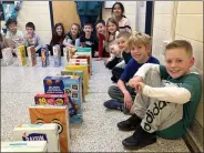 ?? SUBMITTED PHOTO ?? West Bradford Elementary School students wait for the school’s Cereal Box Challenge dominoes to fall.