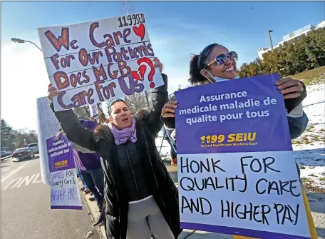  ?? MATT STONE — BOSTON HERALD ?? Hospital workers including Deja Torres, left hold signs as they rally in front of Brigham and Women’s Faulkner Hospital in Jamaica Plain last month. A new contract has now been inked.