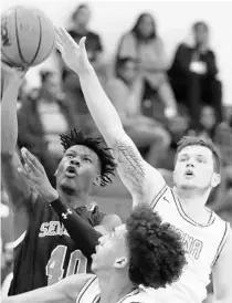  ?? STEPHEN M. DOWELLL/ORLANDO SENTINEL ?? Seminole guard Anthony Coefield (40) shoots as Lake Nona’s Austin Allison (right) defends in a Metro vs. Florida Challenge game at Apopka on Nov. 27. Seminole won 93-64.