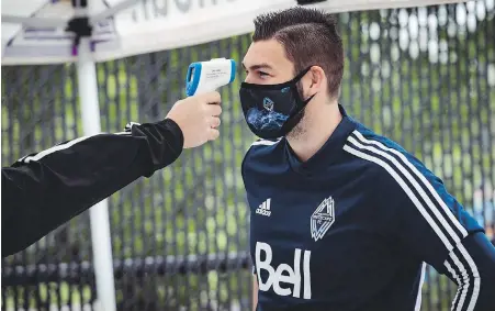  ?? VANCOUVER WHITECAPS VIA CP ?? Whitecaps ’keeper Maxime Crepeau gets his temperatur­e read prior to training Tuesday at UBC.